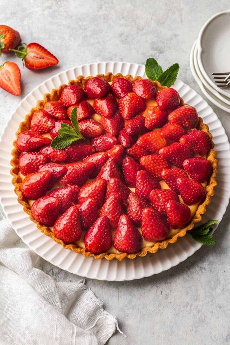 This French Strawberry Tart (Tarte aux Fraises Classique) combines a buttery sable pastry with silky smooth vanilla pastry cream custard. Topped with fresh strawberries coated in a sweet marmalade glaze, this classic tart recipe is the ultimate dessert straight out of a pastry shop. French Tarts, Vanilla Pastry Cream, French Tart, Cream Custard, Bean Pods, Strawberry Tart, Tart Shells, French Dessert, Tart Recipe