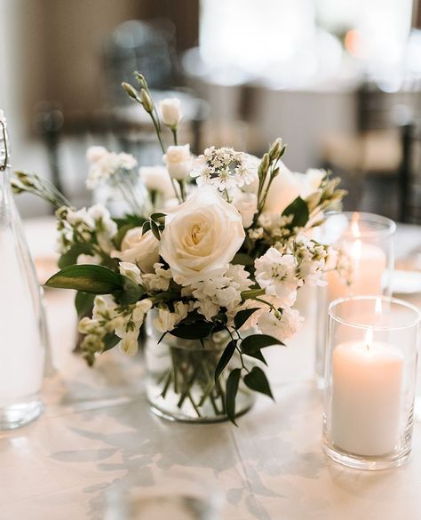 Sweet and petite wedding centerpiece

Vase centerpiece with white roses, white lisianthus, white larkspur, ruscus greens, votive candles
⁠ White Centerpiece Wedding Simple, Simple White Centerpieces Flower, Elegant Simple Centerpieces Wedding, Small White Centerpieces Wedding, Simple Rose Centerpiece Wedding, Simple White Rose Centerpiece, Wedding Floral Decor Reception Ideas, Simple White Wedding Florals, Small White Flower Arrangements