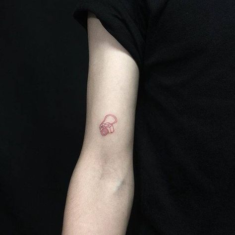 Red ink reflex camera tattoo on the right bicep. Camera Aesthetic Tattoo, Camera Fine Line Tattoo, Fine Line Camera Tattoo, Small Camera Tattoo, Polaroid Tattoo, Personal Tattoos, Camera Tattoo Design, Camera Tattoos, Hidden Tattoos