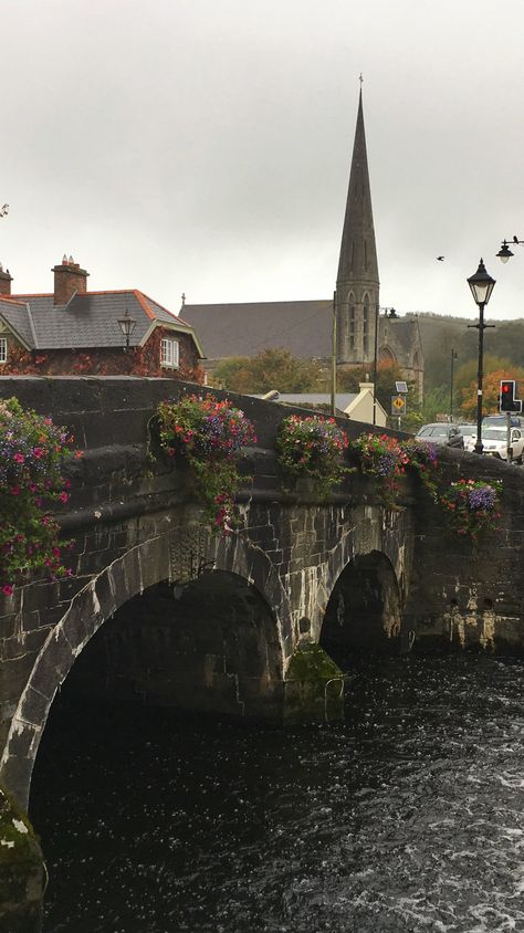 A lovely historical bridge over Carrowbeg River. This is Westport in County Mayo, Ireland on the Wild Atlantic Way. Voted as the best place to live in Ireland, #Westport is an adorable small town in Co Mayo. There are pretty streets, flowers, delicious food and a lovely historical mansion - Westport House. #travel #wildatlanticway Rainy Ireland Aesthetic, Old Ireland Aesthetic, Living In Ireland, Ireland Travel Aesthetic, Ireland Living, Historical Mansion, Western Ireland, Irish Aesthetic, Westport Ireland