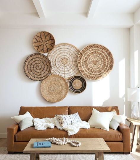 Pottery Barn on Instagram: "Empty wall? Add effortless style with three-dimensional artwork like our Handwoven Basket Wall Art 🙌 Not only do they bring in texture, but the natural material adds warmth to the space as well." Wooden Frames On Wall Home Decor, Woven Baskets On Wall, Basket Wall Decor Modern, Basket Wall Collage, Cane Wall Decor, Boho Basket Wall Art, Basket Walls Boho Living Room, Wicker Basket Wall Art, Couch Wall Decor Ideas