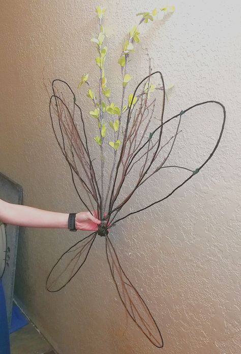 Floral wire, metal coat hanger, twigs, and some artificial flowers Wire Hanger Fairy Wings, Coat Hanger Fairy Wings, Fairy Wings Flowers, Secret Garden Costume Ideas, Woodland Fairy Wings Diy, Woodland Faerie Costume, Woodland Fairy Costume Ideas Diy, Dark Forest Fairy Costume, Homemade Fairy Wings