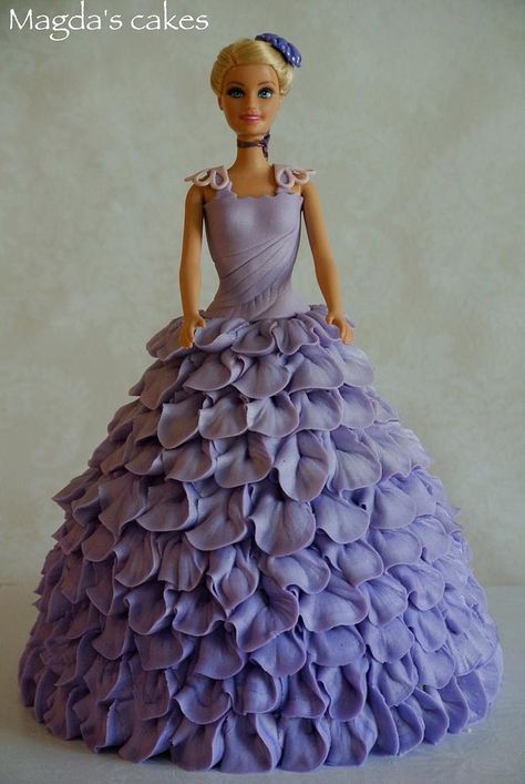 I love doll cakes (or as I should say, I love to play dress-up); This one is dressed in light purple petal dress in buttercream (I decided to try something else than regular buttercream rosettes or ruffles) Barbie Cake Purple, How To Make A Barbie Dress Cake, Barbie Doll Dress Cake, Purple Barbie Cake, Barbie Cake Dress, Clown Cones, Doll Cake Buttercream, Princess Dress Cake, Dress Cakes