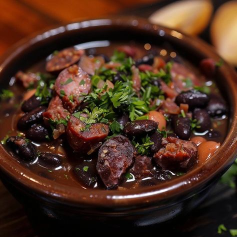 🥘 Embrace the soulful warmth of Brazilian Feijoada! 🇧🇷 🍽️ Feijoada 🛒 Ingredients: Black beans: 1 lb Pork shoulder: 2 lbs Smoked sausage: 1 lb Bacon: 1/2 lb Onion: 1, chopped Garlic: 3 cloves, minced 👩‍🍳 Instructions: Cook: Sauté bacon, sausage, pork until browned. Simmer: Add beans, onion, garlic, and water. Season: Cook slow until rich and thick. 🌟 Warm up with a hearty bowl of Feijoada, a Brazilian treasure! #FeijoadaFiesta #BrazilianCuisine Brazilian Feijoada, Meals Of The Day, Instagram Recipes, Twisted Recipes, Bacon Sausage, Trending Recipes, Brazilian Food, Pork Shoulder, Smoked Sausage