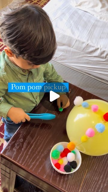 Madiha and Faham| kids play ideas on Instagram: "Pom pom pick up; Working with tongs is the perfect toddler activity for developing fine motor skills, hand/eye coordination and building hand strength. I have also read that mastering the skills of using tongs is necessary before moving on to scissors – the action is fairly similar. This is a simple and frugal way of getting some practice. Materials Balloon Double sided tape Pom poms Tongs/ tweezer Blow a balloon, tie it. Put double sided tape on it, and peel it from other side. Attach pom poms on it. Your can ask your kid to attach pom poms on it. Then give him tong to pluck them from balloon. #finemotorskills #finemotoractivity #montessorieverywhere150 #montessoriathome #preschoolactivities #toddlerplay #playideas #diyplayideas #thursdaym Toddler Balloon Activities, Balloon Activities For Toddlers, Pom Pom Activities For Toddlers, Pom Pom Activities, Kids Play Ideas, Developmental Therapy, Toddler Fine Motor Activities, Playgroup Activities, Hand Eye Coordination