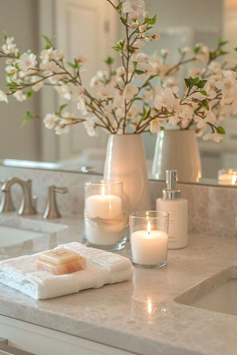 Mix warm neutral tones with reflective surfaces to craft a bathroom that's both cozy and elegant. This approach uses subtle glamour to enhance a comfortable setting. For more warm neutrals with reflective accents ideas, click here. Bathroom Vignettes Display, Classy Academia Aesthetic, Spa Set Up Ideas, Bathroom Spa Decor Ideas, White And Beige Bathroom, Neutral Bathroom Decor Ideas, Earthy Modern Bedroom, Bathroom Counter Ideas, Bathroom Styling Ideas