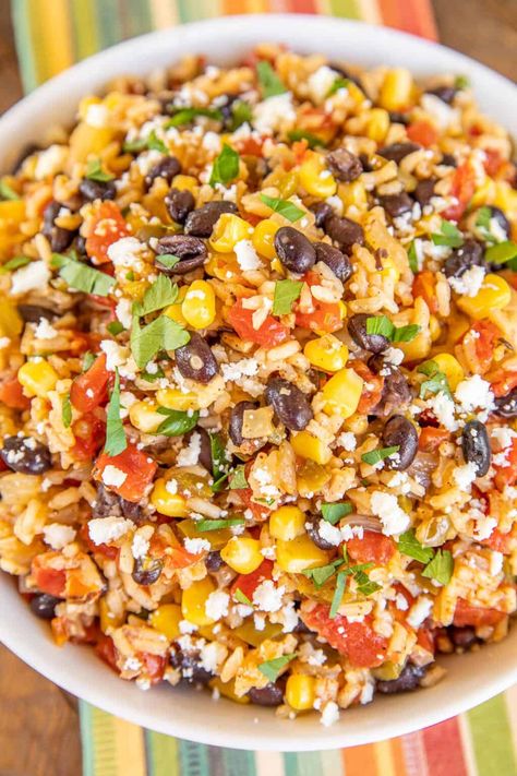 Southwestern Skillet Rice - our go-to side dish for all of our Mexican dishes. Rice loaded with cumin, chili powder, Rotel tomatoes, corn, black beans, onions, bell peppers, and garlic. I could make a meal out of this yummy rice! This is super easy to make and tastes fantastic! Ready in under 30 minutes. It goes great with everything - tacos, enchiladas, casseroles, and grilled chicken and steak! #meatless #mexican #rice #skillet Mexican Rice With Veggies, Black Beans Corn Rice Burrito Bowls, Mexican Rice With Corn And Black Beans, Mexican Rice Pilaf Recipe, Southwest Rice Casserole, Rice And Tomatoes Recipe, Beans And Rice Main Dish, Sauteed Rice Recipes, Mexican Corn And Rice