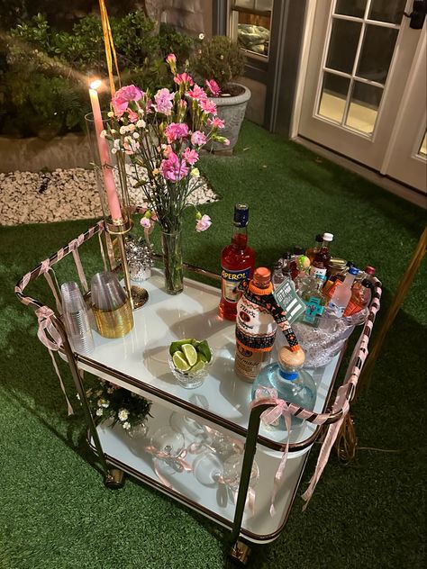 Decorated bar cart for 21st birthday dinner wirh pink ribbons and balloons 21st Birthday Bar Cart, 21st Birthday Ideas College, Mini Bar For Party, Decorated Bar Cart, College 21st Birthday Party, 21st Birthday Ideas Decorations Outdoor, 21st Birthday House Party Ideas, Birthday Bar Ideas, Birthday Bar Cart