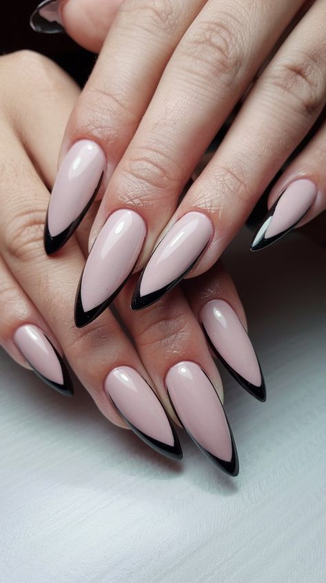 Stand out with an edgy yet elegant design! This nail art showcases a light pink base adorned with sharp black edge stripes running vertically down each nail. The contrast creates a bold statement while maintaining a polished feel. Perfect for fashion-forward individuals looking to make a statement! #EdgyNails #StripedNails #NailDesign Nails Sharp Almond, Black And Pink Almond Nails, Goth Almond Nails, Outline Nails Design, Nails Sharp, Edgy Elegance, Edgy Nails, Spooky Szn, Striped Nails