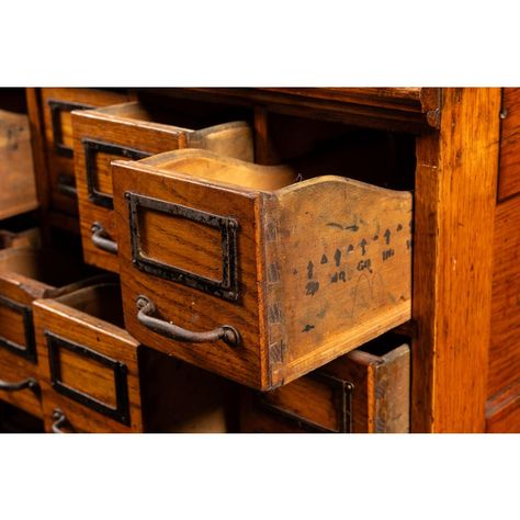 Quarter-sawn solid oak card catalog with 35 storage drawers of uniform size. The catalog portion detaches from the wheeled base for ease of transportation. Each drawer includes the original tin nameplates and iron drawer pulls.  Exhibits minor signs of wear and retains original varnish.  29.5" W x 23.5" D x 53.5" H Drawers (x35): 4.25" W x 20" D x 4" H Vintage Library Card Catalog, Card Catalog Diy, Library Card Catalog Cabinet, Steampunk Office, Card Catalog Cabinet, Vintage Filing Cabinet, Iron Drawer Pulls, Library Card Catalog, Letterpress Drawer