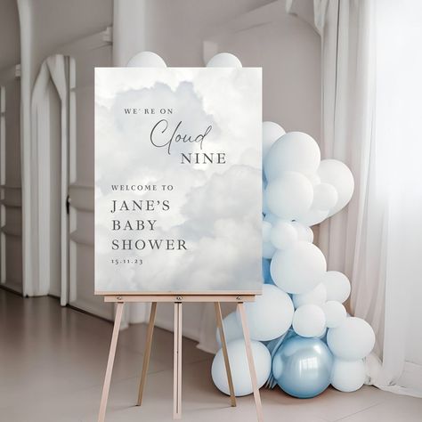 With our charming Cloud Nine Baby Shower Welcome Sign, you can greet your visitors in style! With its lovely cloud motifs and gentle, neutral tones, this adorable entry sign creates the ideal atmosphere for your celestial event. Our printable welcome sign is a lovely accent to your baby shower theme and a lovely banner that perfectly embodies your Cloud Nine theme. Let your guests' first impression of the wonderful event that awaits them be this tasteful welcome board! For matching items 👇🏻 ht Cloud Theme Party Centerpieces, Welcome To Our Baby Shower Sign, Baby Shower On Cloud 9, On Cloud 9 Backdrop, Love You To The Moon Baby Shower Theme, Hanging Clouds From Ceiling, Miracle Baby Shower Theme, Cloudy Baby Shower Theme, On Cloud 9 Baby Shower Theme Boy