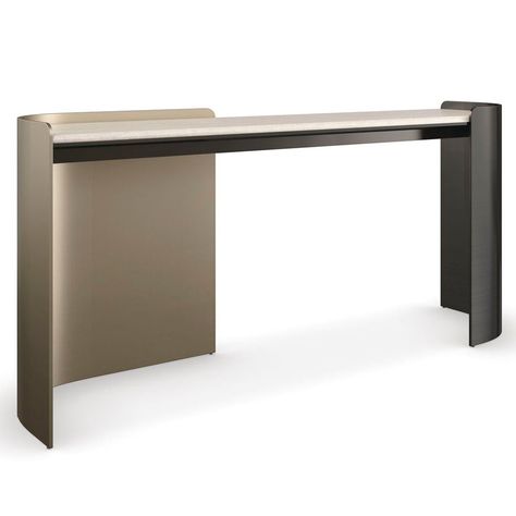 With an inherent rhythm and sleek design, the Caracole Movement console is fluid in both form and function. Artfully integrating sensual curves with muted lines, a Creme Travertine stone top is balanced on metal legs in contrasting bronze finishes for added drama. Makes an alluring statement in halls, entryways, and home offices as a minimalist desk. 68in W x 16.75in D x 31in H Finish: Chocolate Bronze, Lucent Bronze Metallic Material: Metal, Stone Crème Travertine stone top. Left metal leg fini Sleek Console, Designer Console Table, Unique Console Table, Contemporary Console, Evil Eye Art, Metal Console Table, Minimalist Desk, Travertine Stone, Entryway Console