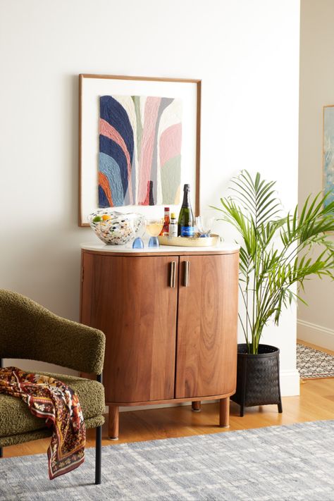 Featuring a curved wood frame in a warm chestnut finish and an oval white marble surface, the Caitlin Marble Top Bar Cabinet packs ample storage into a compact size. It opens to a large compartment with stemware racks, storage for wine bottles, and space for barware. With a genuine marble surface for serving, this versatile bar cabinet makes a lovely impression when entertaining. #WorldMarket #CaitlynBarCabinet #BarCabinet #MarbleCabinet #DiningRoomDecor #HomeBar Marble Bar Top, Bar Cabinet, Moroccan Style, Front Room, World Market, Slate Blue, Autumn Home, Marble Top, Home Collections