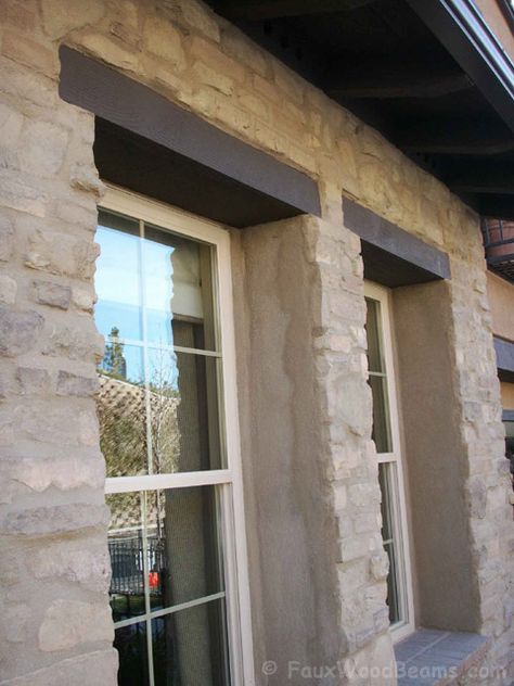 Fake wood window headers can be used on stone houses, too. Recessed Windows Exterior, Faux Cedar Headers Above Windows, Wood Lintel Over Window, Wood Beam Above Window Exterior, Window Lintel Exterior, Wood Over Window Exterior, Wood Beam Window Header Exterior, Wood Headers Over Exterior Windows, Window Headers Exterior