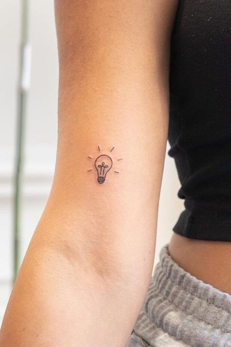 27 Unique Tiny Tattoos (Ideas, Designs & Meanings) #tattoo #art #outline #template #portfolio #idea #neck #minimalist #inspiration Tattoo Ideas Teacher, Small Teacher Tattoos, Light Tattoos For Women, Therapy Tattoo Ideas, Teacher Tattoo Ideas Simple, Photography Tattoo Ideas, Tiny Tattoos Ideas, Light Bulb Tattoo, Therapy Tattoo