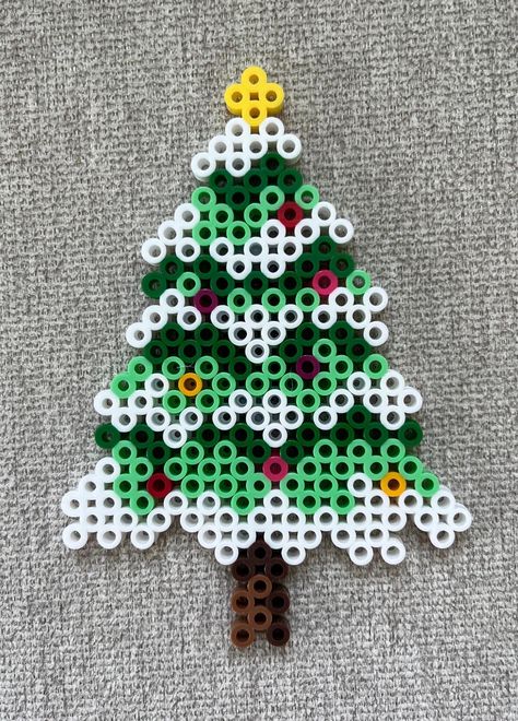 Christmas tree perler bead magnet made with white, green, mint, brown, yellow, red, pink and magenta beads. Melt Beads Christmas Ornaments, Peeler Bead Ornament, Christmas Hammer Beads, Perler Beads Holiday Patterns, Hama Beads Christmas Tree, Gingerbread Perler Beads, Christmas Fuse Beads Ideas, Pearler Bead Christmas Patterns, Christmas Tree Hama Beads