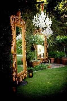 A garden goes glam with oversized gold mirrors.