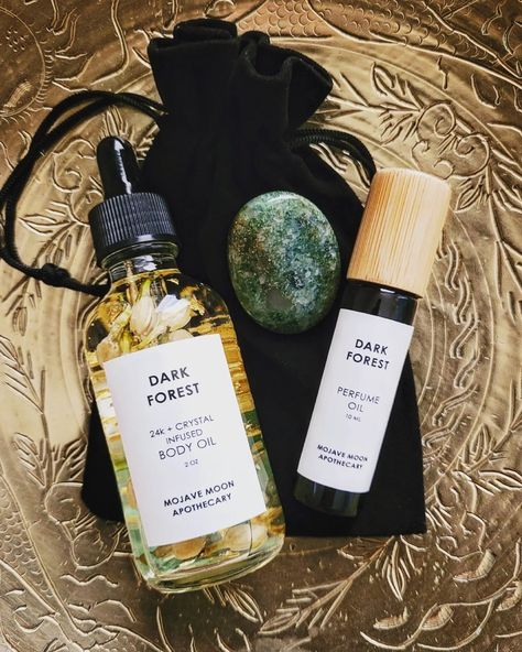 Introducing our new self care bundles in our two best selling scents. Includes one body oil, one perfume, and one worry stone packaged in a black velvet bag. Choose from Dark Forest & Aventurine or Desert Rose & Rose Quartz. Body Oil Packaging, Labeling Ideas, Mojave Moon, Self Care Basket, Skincare Lifestyle, Homemade Perfume, Skincare Branding, Fragrance Ingredients, Products Photography