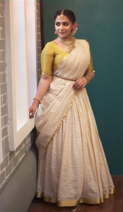 Anu Sithara in a kasavu lehenga by Mirach for onam Kerala Onam Dress For Women, Kasavu Lehenga, Anu Sithara, Onam Special Dress For Women, Dawani Designs Kerala Style, Kasavu Half Saree, Kasavu Saree Blouse Designs, Kasavu Skirt And Top, Onam Dress Ideas