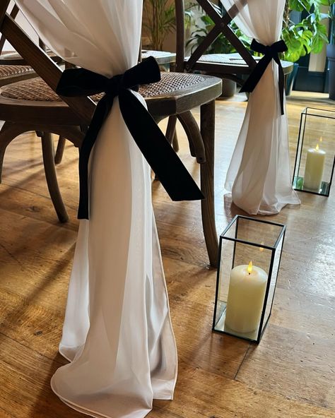 SIDE SWEEP 💫 For when you want something a little special for your aisle, try a gorgeous side sweeping drape complete with velvet bow 🖤 @ambienceleeds @the_faversham . . . . #weddings #weddingday #weddingideas #weddinginspo #weddingdecor #weddingdecorideas #weddingstyle #weddingtrends #bows #bowtrend #chairdecor #weddingchairs #blacktiewedding #ceremonydecor #aislestyle #weddingaisle #leedswedding #leedsbride #weddingstylist #venuestylist #stylishwedding Bow Aisle Markers, Bows On Aisle Chairs, Bow Aisle Decor, Black Chair Sashes Wedding, Black And White Aisle Decorations, Aisle Bows For Wedding, Bow Wedding Decor, Wedding Chapel Ideas, Chapel Ideas