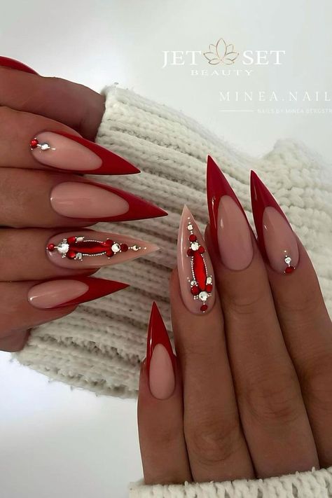 This bold stiletto manicure pairs striking glossy red with subtle nude shades. Featured nails display a captivating line work design embellished with tiny silver beads and red accents, creating an elegant contrast that's both edgy and chic. Perfect for adding a touch of glamour to any outfit.  // Photo Credit: Instagram @minea.nails Stiletto Christmas Nails, Pink Stiletto Nails, Stiletto Shaped Nails, Red Stiletto Nails, Sophisticated Manicure, Christmas Nail Ideas, Pointy Nails, Red Christmas Nails, Nude Nail Designs