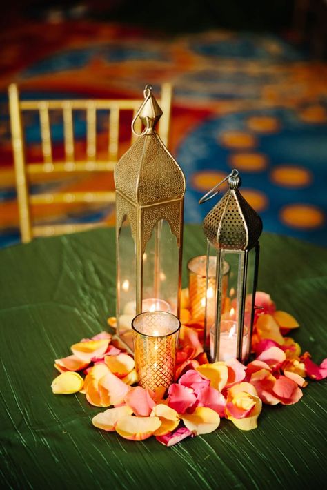 Garba, Sangeet, Mehndi, Lantern, Candle, Flower Petals, orange, yellow, flower, lotus, bronze, candle, green Indian Lantern Centerpieces, Mehndi Decor Centerpieces, Indian Wedding Centerpieces Diy, Indian Wedding Table Decorations Centerpiece Ideas, Mendhi Centerpieces Table Settings, Indian Lantern Decor, Mehndi Centerpieces Diy, Sangeet Table Centerpieces, Mehndi Table Decorations