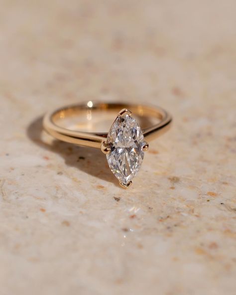 Fun fact - because of their cut, marquise tend to look bigger than their carat weight ✨ This gorgeous solitaire style features a lifted cathedral setting to allow for a straight wedding band to sit flush. Details: - 1.28ct marquise diamond - 14k yellow gold - 1.8mm wide shank #marquiseengagementring #nz #labgrowndiamond #customengagementring #aus Gold Marquee Engagement Ring, Marquise Cut Wedding Rings, Yellow Gold Anniversary Rings, Engagement Ring Classic, Bride Birthday, Marquise Cut Rings, Anniversary Rings For Her, Marquise Diamond Ring, Ring Proposal