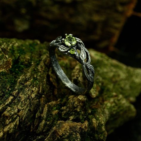 This exquisite ring features intricate details of an olive branch and leaf, offering a unique and nature-inspired design perfect for a fantasy-themed, woodland engagement. Its non-traditional charm and feminine woodsy aesthetic make it a symbol of everlasting love amidst the enchanting beauty of nature. Characteristics: Metal - Recycled solid sterling silver  Stone - Cubic Zirconia Finish - Oxidized. View all silver forest rings: https://www.etsy.com/shop/TinyShinyJewel?ref=seller-platform-mcnav&section_id=43358995 Care instructions: To care for the ring, avoid contact with water and chemicals such as perfumes and lotions. When the ring is not in use, store it in a dry, cool place to prevent tarnishing. Additional information:  ✦ All rings are made to order. An average turnaround time is 1 Forestry Wedding Rings, Forest Rings Engagement, Simple Earthy Wedding Rings, Nature Inspired Wedding Ring Silver, Forest Engagement Rings, Medevil Engagement Rings, Forest Themed Wedding Ring, Fantasy Rings Aesthetic, Unconventional Wedding Rings Silver