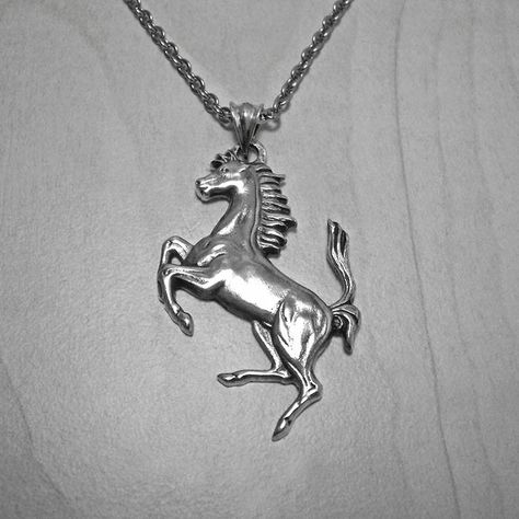 "🌟⚜️FREE SHIPPING ITEMS OVER 250€, NEED A PHONE NUMBER FOR DHL EXPRESS⚜️🌟 🌟⚜️ADD IT TO THE NOTE TO SELLER, OR MESSAGE ⚜️🌟 A mens sterling silver pendant. The \"Ferrari\" horse, as a mens pendant. The Prancing Horse Is the symbol of Italian sports car manufacturer Ferrari and its racing division Scuderia Ferrari. Originally, the symbol was used by World War I pilot Francesco Baracca on his airplane. According to Ferrari, Enzo took the logo from an image of a red horse painted on the fuselage Classic Necklace With Horse Design For Gift, Gold Pendant Necklace With Horse Design, Elegant Horse Design Pendant Jewelry, Luxury Silver Horse Design Necklace, Luxury Horse Design Pendant Necklace, Silver Horse, Horse Necklace, Horse Jewelry, Horses Pendant