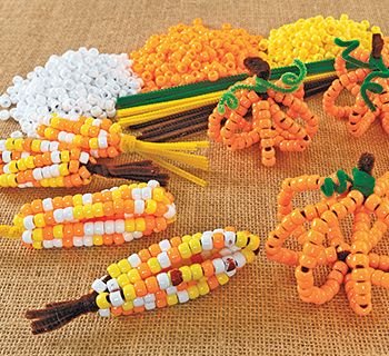 Pony Bead Corn & Pumpkins – Colorations® Pony Bead Pumpkin Craft, Corn Made Out Of Beads, Pony Bead Corn Cob, Corn Prek Activities, Pumpkin Pony Bead Craft, Preschool Bead Crafts, Corn Cob Painting, Thanksgiving Beaded Crafts, Pony Bead Corn Craft