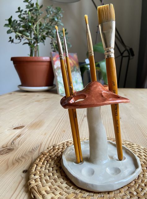 Mushroom pen and brush holder will enhance the aesthetics of any room within your home! 🍄🌱 It is made out of clay, painted and glazed. Check it out on etsy shop: KBmushROOM!💖 #mushroom #clay #gift #handmade Pottery Paintbrush Holder, Clay Crafts For Room Decor, Paint Brush Clay Holder, Clay Room Decor Aesthetic, Clay Paint Holder, Useable Clay Projects, Pen Holder Diy Clay, Useful Sculpture, Cool Clay Ideas Easy