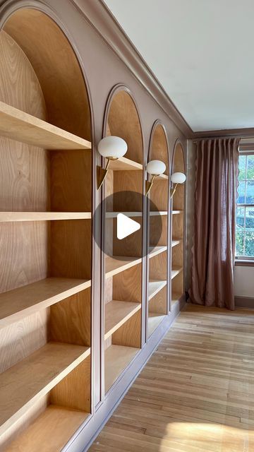 Jourdan Fairchild on Instagram: "These living room bookshelves were a *true* labor of love, and here’s digestible glimpse of what it took to build them from scratch.✨  1. We removed the original crown molding and baseboards.  2. After transporting 192,192,827 boards on top of our small SUV (#weneedatruck), Andrew built the basic framework for the shelves.  3. He extended an electrical outlet from the floor board so we could later install three sconces between the four bookshelves. That part still amazes me, tbh.  4. After much trial and error, we realized it’d be best to build the actual birch bookshelf boxes outside and then bring them in. It’s an old house, this wall bows a bit, and this reframing (ha) would give us that beautiful continuous wood piece along the back of each shelf.  5. I Built In Bookshelves With Sconces, Built In Arch Bookcase, Bookcase Crown Molding, Diy Wood Bookcase, How To Build Bookshelves, Built In Floor To Ceiling Bookshelves, Wooden Built In Bookshelves, How To Build A Bookshelf Wall, Book Shelf Wall Ideas Living Room