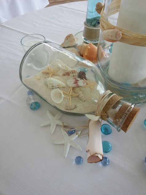 Beach wedding on a dime! Goodwill bottle with collected shells Seashell Themed Party, Beach Theme Wedding Reception Tables Centerpiece Ideas, Classy Beach Theme Party, Beach Themed Table Centerpieces, Ocean Themed Centerpieces, Beach Centerpieces Diy, Ocean Centerpieces, Beach Wedding Table Centerpieces, Sea Themed Birthday Party