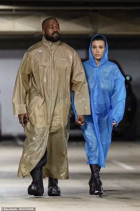 Bianca Censori struggles to protect her modesty as she goes NUDE under a clear raincoat for a studio session with mask-clad husband Kanye West | Daily Mail Online Kanye West Closet, Controversial Fashion, Kanye West Show, Ozzy And Sharon Osbourne, Ozzy And Sharon, Kanye West Wife, Clear Raincoat, Mesh Outfit, Balenciaga Jacket