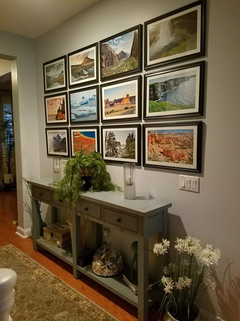 Photo wall great way to display your trips. Display Photography At Home, How To Display A Lot Of Pictures, Display Landscape Photos, Family Photos Displayed In Home, Displaying Vacation Photos, Travel Photo Collage Wall, Nature Photo Wall, Travel Photo Gallery Wall, Vertical Photo Wall Display