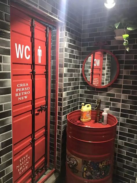 Garage Theme Cafe, Automotive Bathroom Ideas, Dive Bar Bathroom, Mancave Bathroom, Garage Bathroom Ideas, Industrial Pub, Mechanic Shop Decor, Container Door, Industrial Bathroom Decor