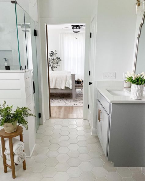 Hexagon tile is very popular, but what's unique about this design is the individual hues of each hexagon piece. Instead of one color palette that extends the length of the floor, there are very subtle creams, grays, and beige tones spread throughout. This is a great way to tie in a statement gray vanity with white shiplap and brown accent pieces. Makoto Hexagon Tile, Bathroom Hexagon Tile Floor White, Bathroom Flooring Ideas Hexagon, Bathroom Floor Tile With White Vanity, Hexagon Tiles In Bathroom, 8 Inch Hexagon Tile Floor, Tile Flooring In Bathroom, Bathroom Floor Tile And Shower Tile, Oblong Hexagon Tile Bathroom