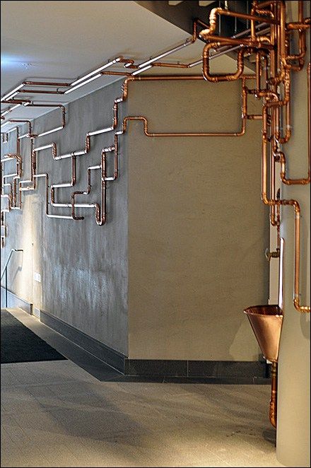 As customer amenity this Copper Water Fountain would catch the eye, even without the runaway copper piping. I’m sure the… Industrial Hallway, Luminaria Diy, Industri Modern, Modern Industrial Interior, Copper Pipes, Copper Bar, Industrial Design Furniture, Industrial Bedroom, Vintage Industrial Style