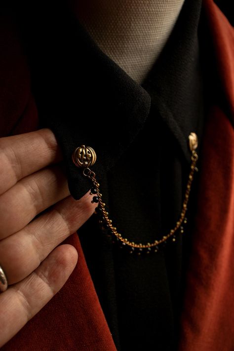 This pumpkin collar pin is one of my more decorative collar pins. A detailed pumpkin, crafted from durable solid (not plated) raw brass with push pin back tacks a black faceted glass bead chain with brass details. This beaded brass chain has that little something extra to make any look that much more fancy.  I added a patina to enhance the vintage feel and highlight the texture. The pumpkins are 9/16 inch tall including the ring and 1/2 inch wide . The beaded chain is 5 inches long.  Be sure to check out my other pumpkin jewelry, such as the lapel pin in the last photo! Please Note Some shirt collars have a hard plastic tab inside them for support. This plastic will need to be pierced with a thick sharp needle or thumbtack before inserting your collar pin piece. Your collar pin is not desi Mens Pants Fashion Casual, Shirt Collars, Pumpkin Jewelry, Pumpkin Pin, Collar Pin, Collar Chain, Goth Style, Collar Pins, Beaded Collar