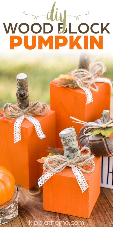 orange 4x4 scrap wood pumpkins with stick stems, twine bow and lace tie on a wood table Diy Fall Decor With 4x4, 4x4 Wood Pumpkins Diy, Small Wood Pumpkins Diy, Easy Fall Wood Crafts Diy, Square Wood Pumpkins Diy, 4 By 4 Wood Crafts, Wood Square Crafts Diy Projects, 4x4 Pumpkins Diy, Scrap Wood Pumpkins