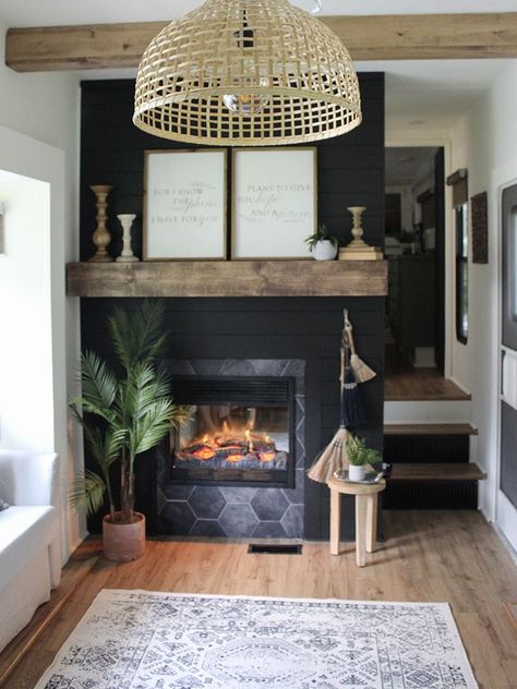 This remodeled RV has the coziest fireplace you've ever seen in a tiny home (and it's for sale!). Featuring @karleemmarsh on MountainModernLife.com #rvrenovation #rvforsale #rvmakeover #blackshiplap #concretecounters #greenkitchencabinets #tinyhome #tinyhomeonwheels #camper #camperforsale #designvibes #rvreno #rvremodel #rvinspiration #rvdecor #campermakeover Camper Trailer Remodel, Diy Camper Remodel, Ikea Living Room, Living Room Light Fixtures, Camper Makeover, Camper Living, Rv Decor, Rv Interior, Camper Decor