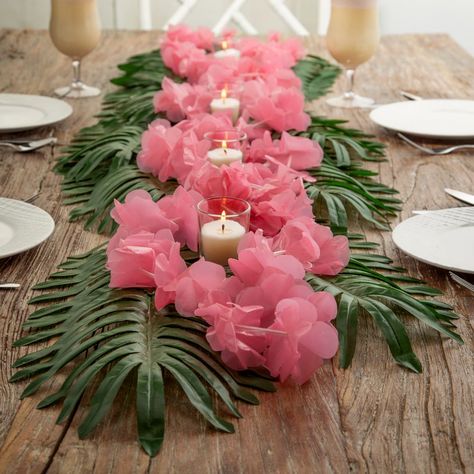 Lei" the table for a terrific tropical celebration! These table decorations bring a hint of Hawaii to your celebration, whatever the occasion. Perfect luau party supplies for a hula-themed bachelorette party or bridal shower, they're elegant, understated, and add instant atmosphere to any celebration space. (48 pcs. per unit)Includes:o 24 Polyester Large Palm Leaves (Leaf, 9" x 18"; stem, 5-1/2".)o 12 Plastic Light Pink Flower Leis (36" x 2 3/4" diam.)o 12 Clear Glass Votive Candle Holders with Candle (2 1/2")o Assortments are subject to change at any time and may vary from picture shown. Substituted items will be similar in nature. Simple Hawaiian Party Decorations, Cute Luau Party Ideas, Hawaiian Flower Decorations, Natal, Hawaii Party Table Decorations, Summer Themed Decorations, Easy Tropical Centerpieces, Luau Theme Dessert Table, Tiki Party Table Decorations