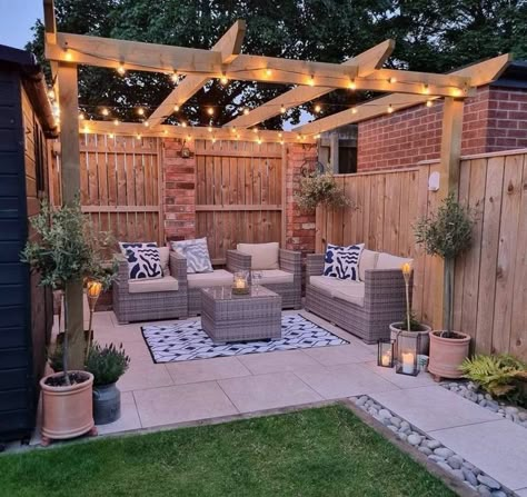 You can also tone things down a bit and opt for a more refined design like this. It features sleeker furniture, lighter colors, and a minimalist aesthetic. Image credit: INSTAGRAM @OURVICTORIANHOME_66 Garden Patio With Pergola, Fenced In Pergola, Backyard Vision Board, Backyard Deck Pergola Ideas, Garden Ideas Pergola, Pergola In Yard, Garden Design With Pergola, Patio With Fairy Lights, Back Garden Design Ideas