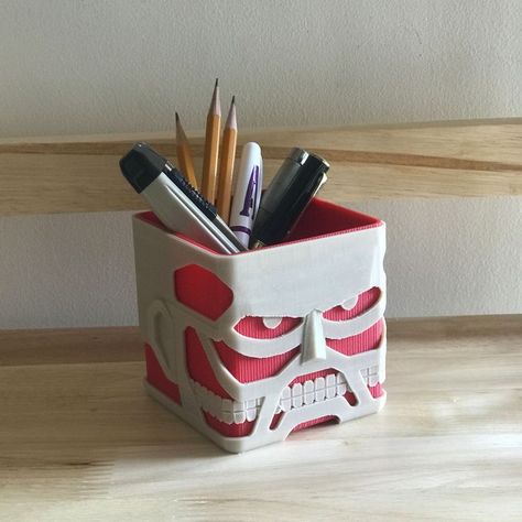 We created a fan-made 3D-printed recreation of the Colossal Titan, one of the franchise's most iconic titans. It can be used as a succulent planter, a pencil holder, a desk organizer, or a personal storage box. It's a great present for any occasion for an Attack on Titan/Shingeki no Kyojin anime manga lover! #Attackontitan#Deskorganizer#Skullplanter #headplanter#3dprintedplanter#anime gift #nerdgift#animeroomdecor#gameroomdecor Colossal Titan, Titan Manga, Chic Headband, 3d Printing Art, Pencil Organizer, Head Planters, Nerd Gifts, Anime Lover, Anime Room