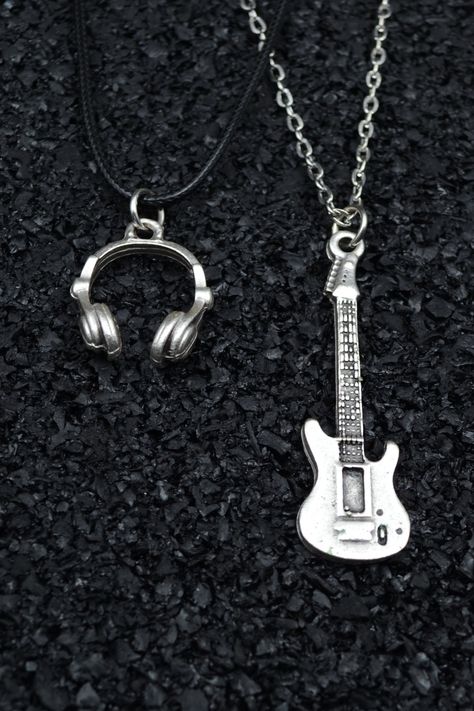 Music-Themed Jewelry Collection: In our store, you can find special necklaces featuring symbols like headphones and an electric guitar, perfect for music enthusiasts. These necklaces also include skull figures, making them ideal gift options for music lovers. Gifts Tailored for Rock and Metal Enthusiasts: Our electric guitar-themed necklaces offer an excellent gift idea for rockers, metalheads, and punk enthusiasts. They represent the raw and rebellious side of music while adding a unique touch to your fashion and style. Original Designs with Symbolic Representations: Adorned with skull and electric guitar details, these necklaces also appeal to punk and hip-hop aficionados. They cater to both women and men, standing out as remarkable music accessories. Special Gift Ideas for Music Lovers: Y2k Jewelry Holder, Grungy Silver Jewelry, Cool Accessories Jewelry, Chains Aesthetic Dark, Skateboard Jewelry, Special Necklaces, Music Themed Jewelry, Guitar Necklace, Chain Types