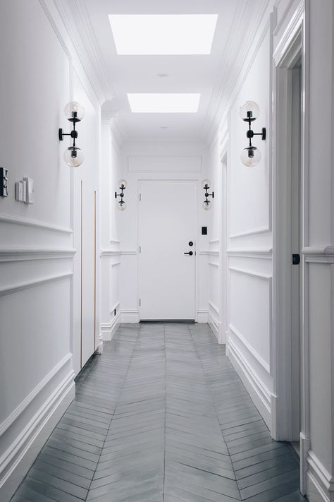 Parisian Meets Industrial — Adore Home Magazine Corridor Design Home, Narrow Hallway Lighting, Monochrome Hallway, White Corridor, Parisian Wall, Hallway Ideas Diy, Parquetry Floor, Entrance Halls, Parisian Decor