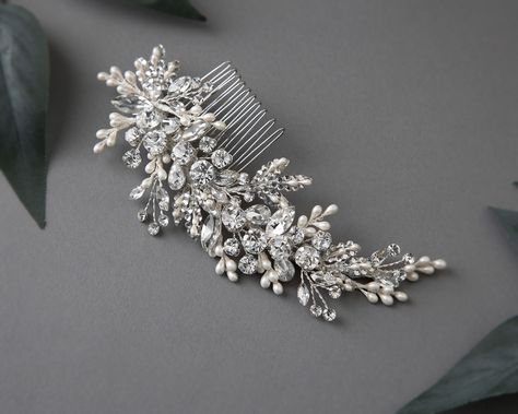 Glamorize your special day with this radiant sparkling wedding hair comb with pearl drops. Reminiscent of a fairy-tale dream, this elegant comb features round and marquise cut crystal stones, delicately accented with ivory pearl drops and crystal-dotted leaves, creating a timelessly mesmerizing effect. Perfect for the modern bride looking to add a touch of elegance and refinement to her look. This side comb measures about 6 inches long and 2 inches high. . #bridalhaircomb #bridalhaircombs #b... Pearl Hair Piece, Sparkling Wedding, Side Comb, Gold Headpiece, Wedding Hair Comb, Sparkle Wedding, Vintage Inspired Jewelry, The Modern Bride, Headband Tiara