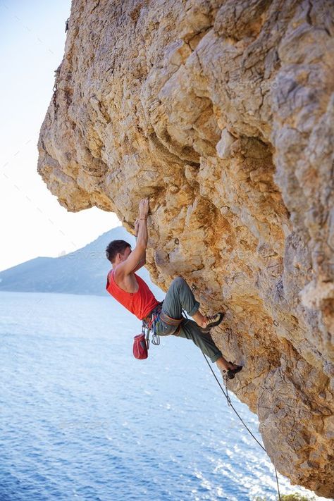 Young man lead climbing on overhanging cliff by photobac. Young man lead climbing on overhanging cliff over water #Affiliate #lead, #climbing, #Young, #man Rock Climbing Workout Beginner, Rock Climbing Aesthetic, Rock Climbing Photography, Kids Rock Climbing, Rock Climbing Outfit, Rock Climbing Workout, Climbing Wall Kids, Lead Climbing, Rock Climbing Gym