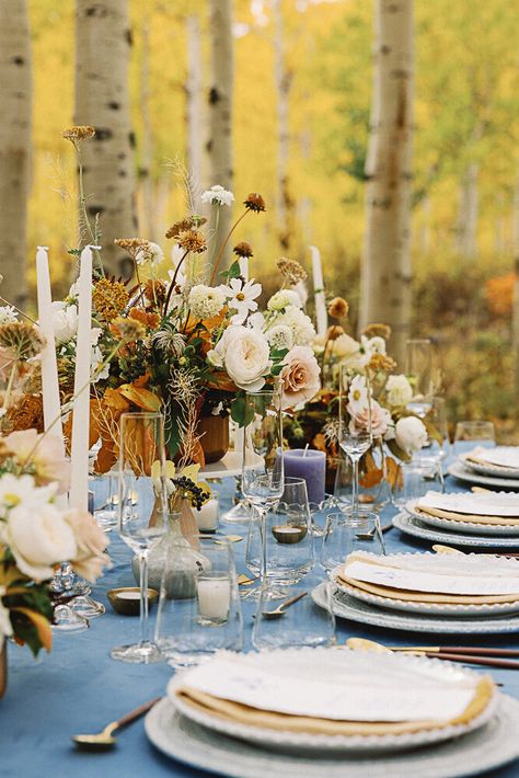 Stacked plates on a wedding table with blue table cloth, gold flatware, foraged flowers, and candles Montana Fall Wedding, Fall Vermont Wedding, Fall Wedding Table Ideas, Wedding Ideas Elopements, Fall Colorado Wedding, Colorado Fall Wedding, Fall Leaf Wedding, Autumn Wedding Ideas, Wedding Table Ideas