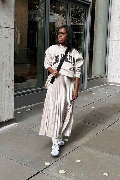 Woman wearing fall outfit sweatshirt and pleated skirt sneakers and skirt adidas samba Sweater With Pleated Skirt, Skirt And Sweatshirt Outfit, Sweatshirt With Skirt, Sweatshirt And Skirt Outfit, Winter Outfits Ideas, Skirt Outfit Fall, Adidas Samba Outfit, Pleated Skirt Outfit, Trending Ideas